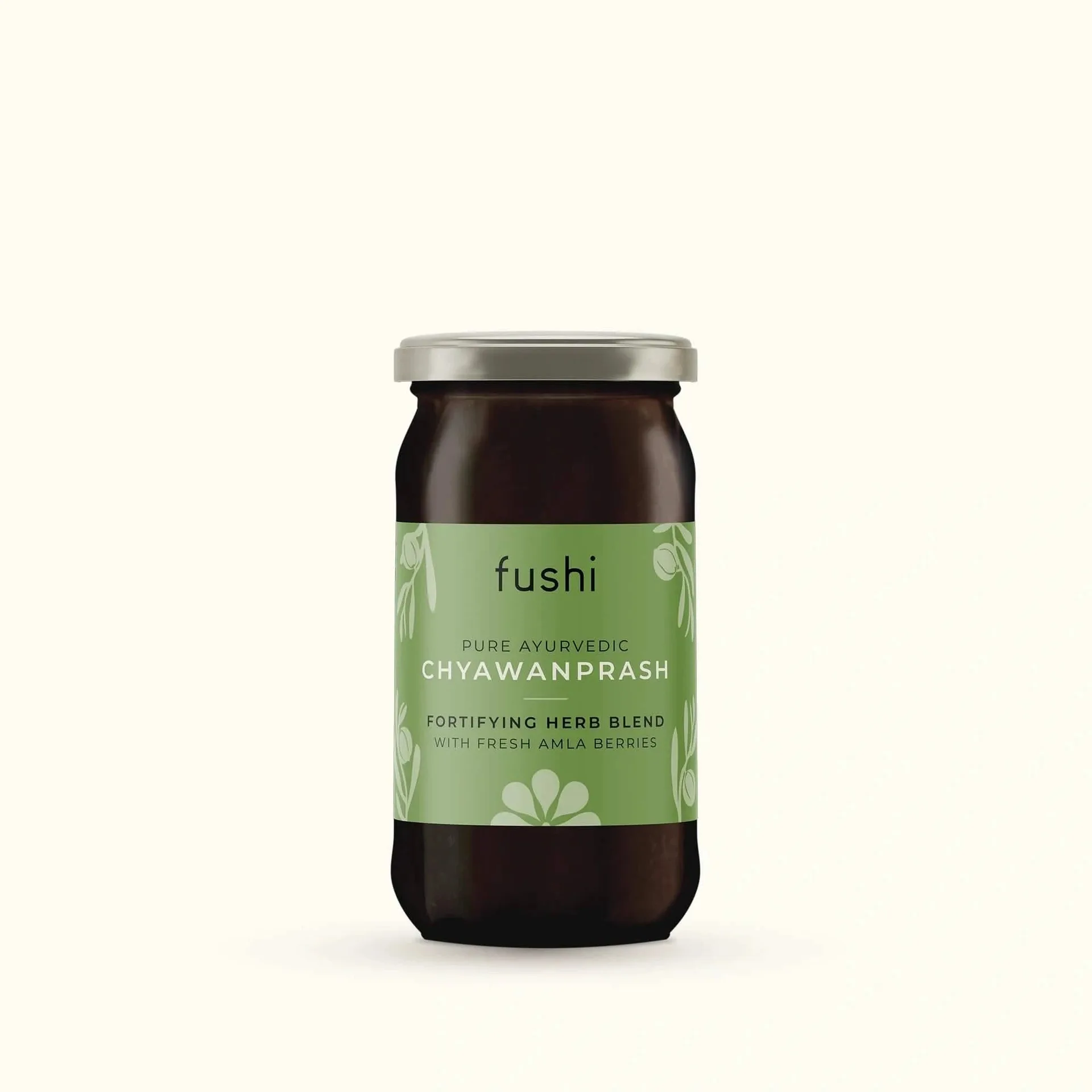 Sklenice Fushi Chyawanprash se zelenou etiketou na světlém pozadí